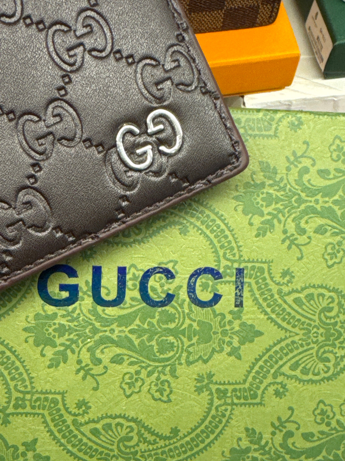 Dark Brown Embossed Monogram Leather Bifold Wallet with Silver Accent