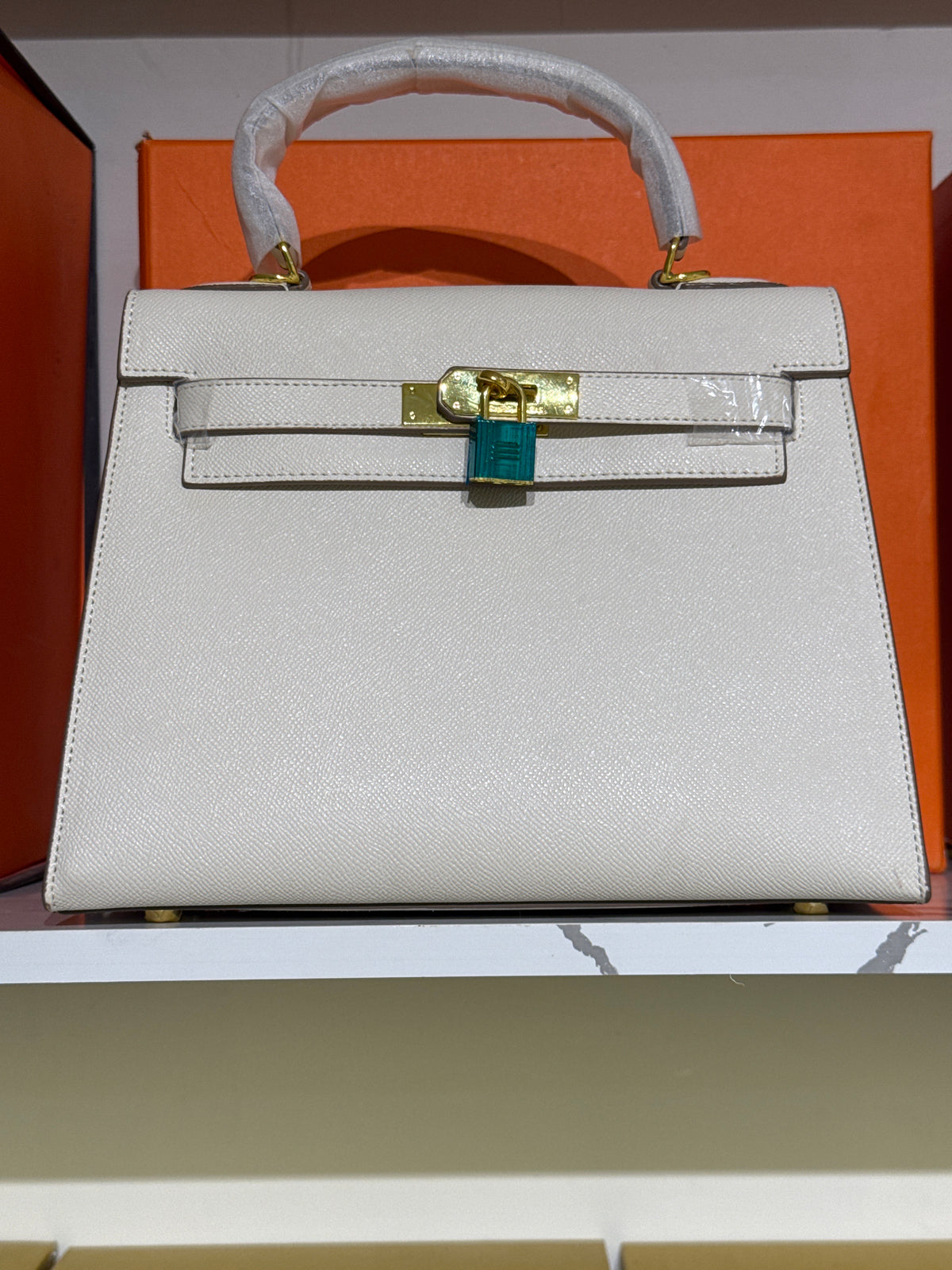 Off-White Leather Top-Handle Structured Handbag with Gold-Tone Lock Accent